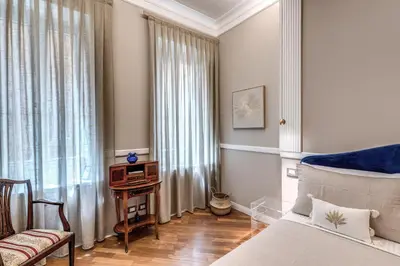 a bedroom with a bed and a tv on a table at Trevi Central Suite in Rome