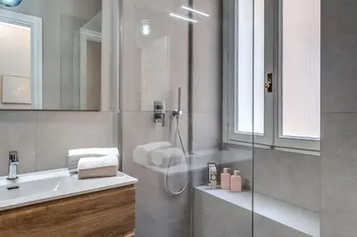 a bathroom with a shower and a sink at Trevi Central Suite in Rome