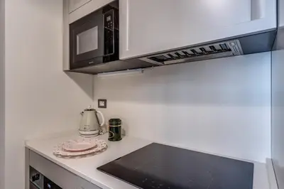 a kitchen with a microwave and a stove top oven at Trevi Central Suite in Rome