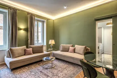 a living room with a couch and a glass table at Trevi Central Suite in Rome