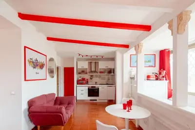 a living room with a red ceiling and a table at Vatican PENTHOUSE in Rome