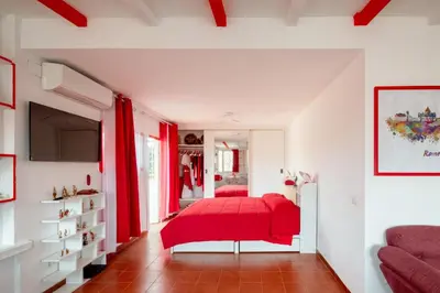 a bedroom with a red bed and red curtains at Vatican PENTHOUSE in Rome