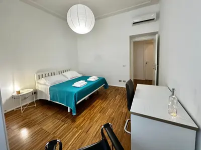 a small room with a bed and a table at La Casabella Rome Center in Rome