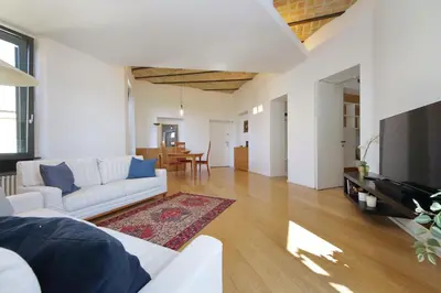 a living room with a white couch and a television at YCH-Splendido attico con terrazzo a San Giovanni in Rome