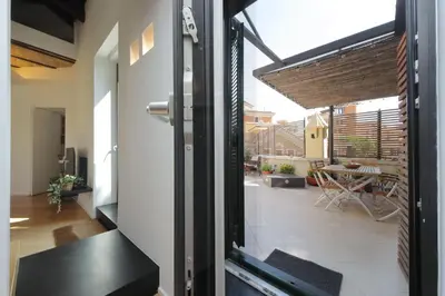 an open door to a balcony with a view of a patio at YCH-Splendido attico con terrazzo a San Giovanni in Rome