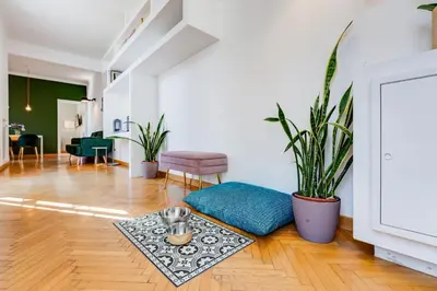 a living room with a couch and plants in it at Attico incantevole con idromassaggio e terrazzo in Rome