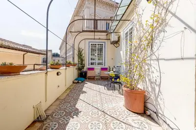 a courtyard with a tile floor and a balcony at Attico incantevole con idromassaggio e terrazzo in Rome