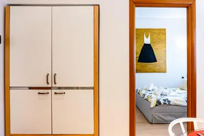 a door leading into a bedroom with a bed at Appartamento Vacanze a Roma San Giovanni - Affitto Breve, Comfort Moderno e Posizione Centrale in Rome