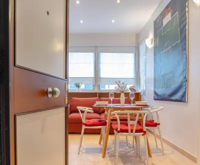 a kitchen and dining room with a table and chairs at Appartamento Vacanze a Roma San Giovanni - Affitto Breve, Comfort Moderno e Posizione Centrale in Rome