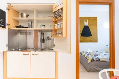 a kitchen with white cabinets and a sink in it at Appartamento Vacanze a Roma San Giovanni - Affitto Breve, Comfort Moderno e Posizione Centrale in Rome