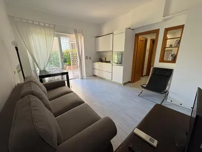 a living room with a couch and a kitchen at La Casa di Valentina in Rome