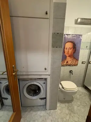 a bathroom with a toilet and a washing machine at La Casa di Valentina in Rome