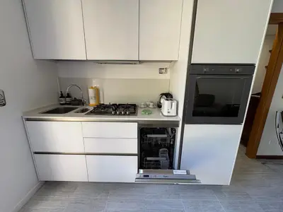 a small kitchen with a stove and a microwave at La Casa di Valentina in Rome