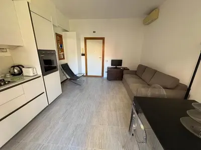 a kitchen and living room with a couch and a table at La Casa di Valentina in Rome