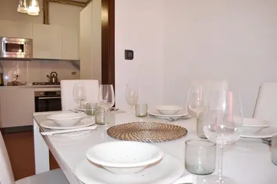 a white table with glasses and plates on it at Apartment in Campo de' Fiori in Rome
