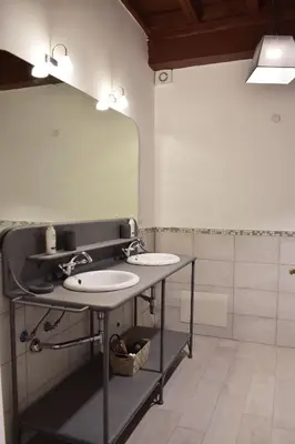 a bathroom with two sinks and a large mirror at Apartment in Campo de' Fiori in Rome