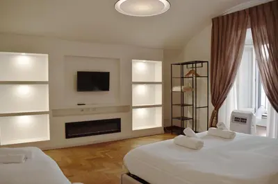 a bedroom with two beds and a fireplace and a tv at Apartment in Campo de' Fiori in Rome