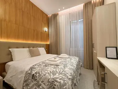 a bedroom with a bed with two towels on it at Luxe roma in Rome