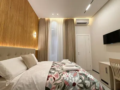 a bedroom with a bed and a tv on a wall at Luxe roma in Rome