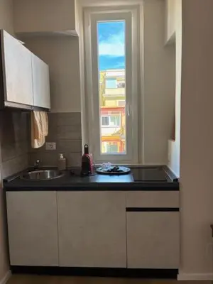 a kitchen counter with a sink and a window at Mila house suite in Rome