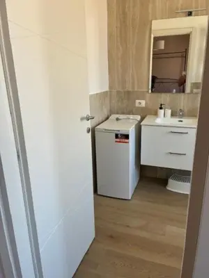 a white bathroom with a sink and a mirror at Mila house suite in Rome