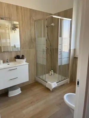 a bathroom with a shower and a sink and a toilet at Mila house suite in Rome