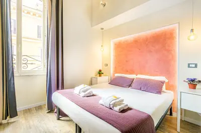 a bedroom with two beds with towels on them at Nicole Suite in Rome