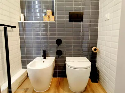 a bathroom with a toilet and a sink at Nicole Suite in Rome