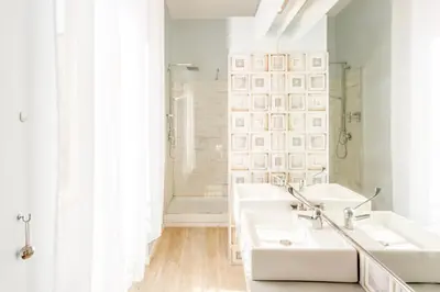 a white bathroom with three sinks and a shower at Nicole Suite in Rome