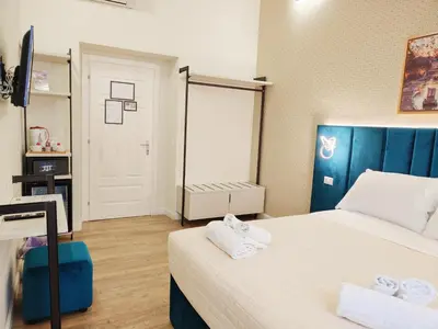 a small room with two beds and a mirror at Nicole Suite in Rome