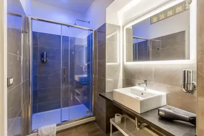 a bathroom with a sink and a shower at Nicole Suite in Rome