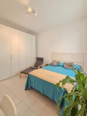 a bedroom with a bed and a chair at Quiet, Cozy flat near citycenter in Rome