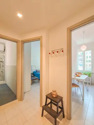 a living room with sliding glass doors and a table at Quiet, Cozy flat near citycenter in Rome
