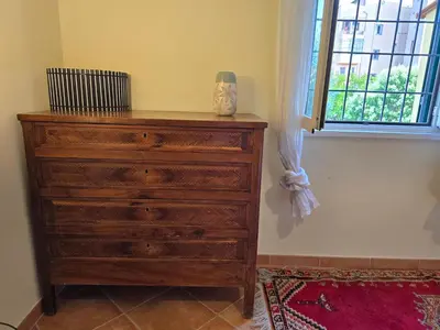 a wooden dresser in a room with a window at Hortus in Rome
