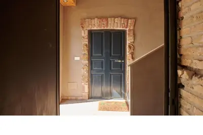 a door leading into a room with a brick wall at Hortus in Rome
