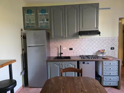 a kitchen with a refrigerator and a table in it at Hortus in Rome