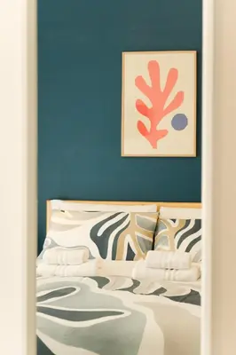 a bedroom with a bed with a blue wall at Domus Paruta in Rome