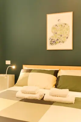 a bedroom with a bed with two towels on it at Domus Paruta in Rome