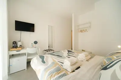 a bedroom with a bed and a desk with a computer at Domus Paruta in Rome