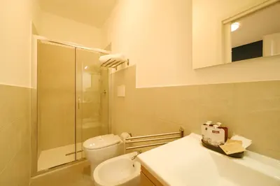 a bathroom with a toilet and a sink and a shower at Domus Paruta in Rome