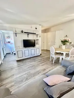 a living room with a couch and a tv and a table at La casa di Roby in Rome