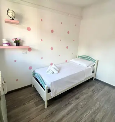 a bedroom with a bed with polka dots on the wall at La casa di Roby in Rome