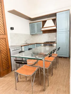a kitchen with a glass table and chairs at Sant'Onofrio Boutique Apartment in Rome
