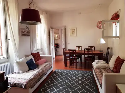 a living room with a couch and a dining room at House of Marzia #6000rome in Rome