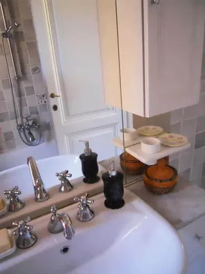 a bathroom with a sink and a mirror and a sink at House of Marzia #6000rome in Rome