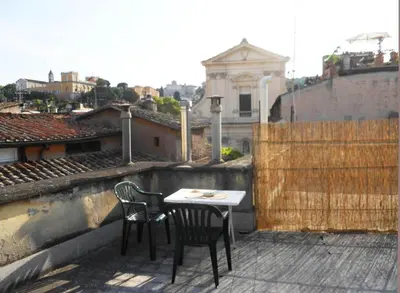 a table and two chairs sitting on a balcony at House of Marzia #6000rome in Rome