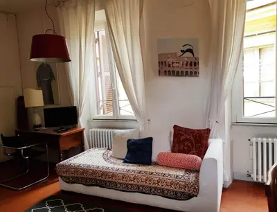 a living room with a couch and two windows at House of Marzia #6000rome in Rome