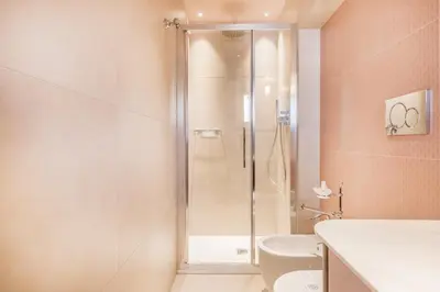 a bathroom with a shower with a toilet and a sink at Sophia B&B 94 Trastevere in Rome