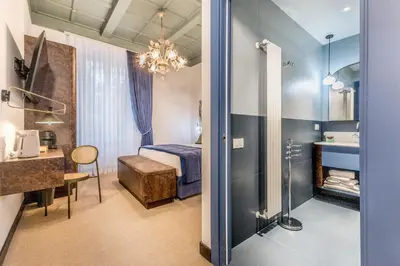a hotel room with a bed and a bathroom at Sophia B&B 94 Trastevere in Rome