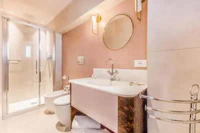 a bathroom with a sink and a toilet and a mirror at Sophia B&B 94 Trastevere in Rome
